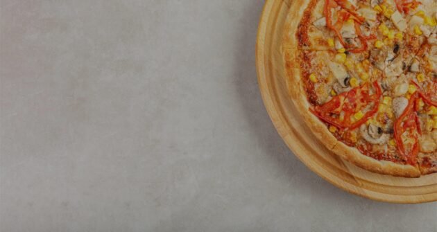 delicious-pizza-with-chicken-mushrooms-cheese-tomatoes-corn-concrete-background-closeup