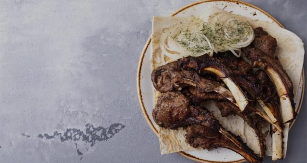 juicy-grilled-lamb-meat-with-onion-plate-top-view-copy-space